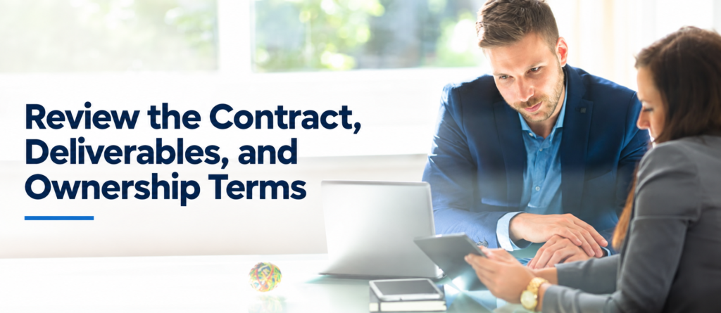 Business consultant reviewing contract, deliverables, and ownership terms with a client during an AI consulting meeting at a desk with a laptop and tablet.